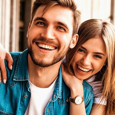 Smiling couple with healthy white teeth – maintaining oral health with premium dental care products and daily hygiene routine.