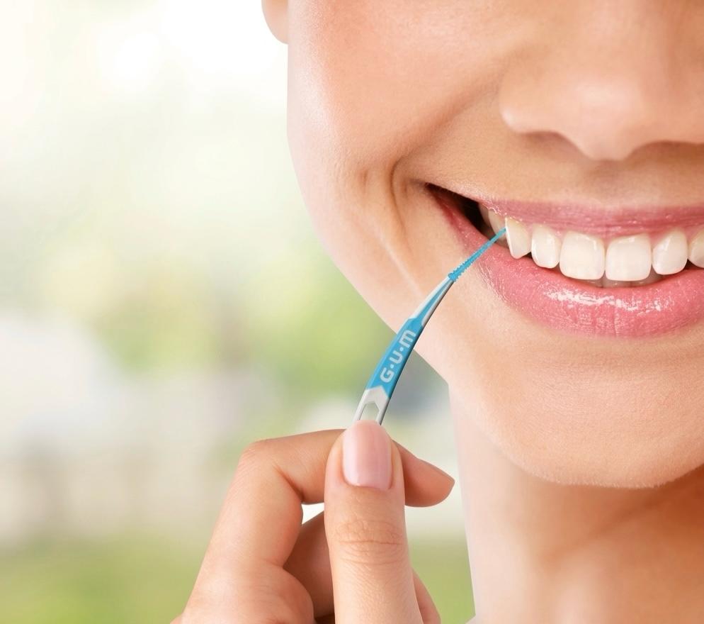 why brushing alone is not enough - dental floss cleaning plaque between teeth