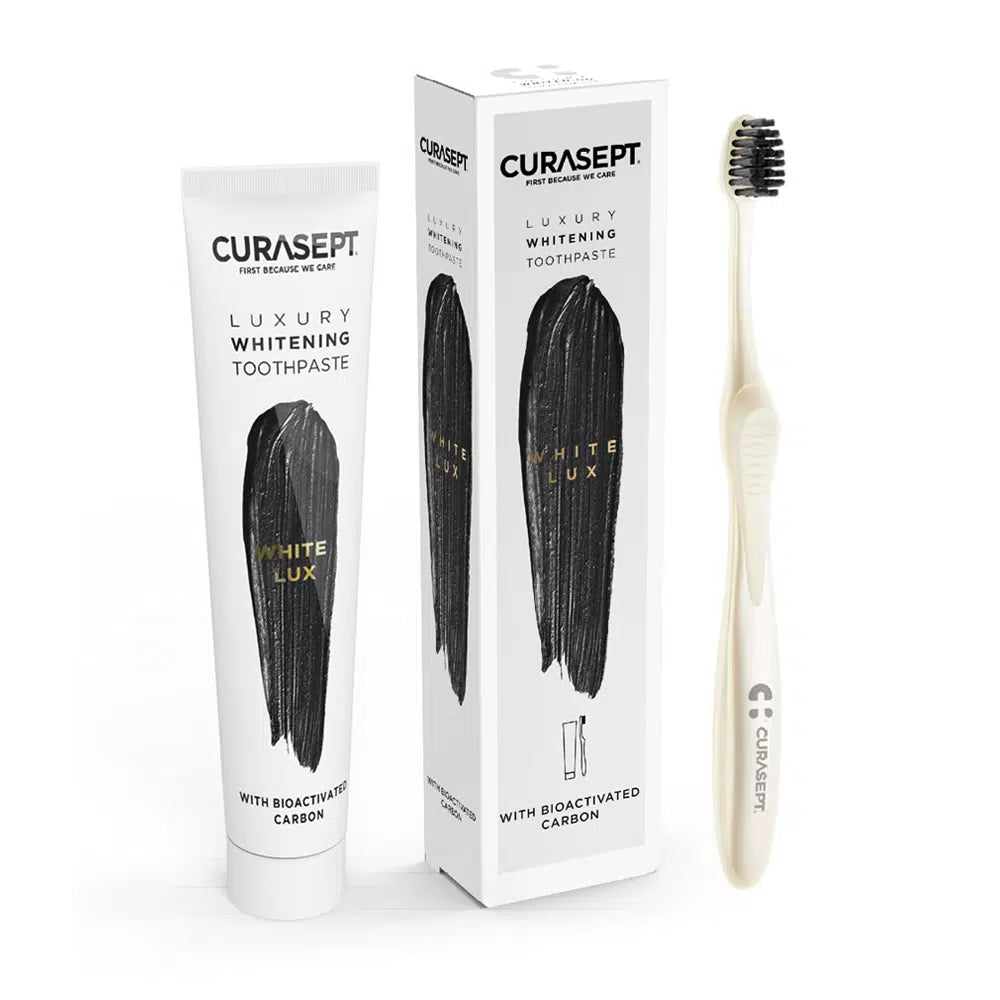Curasept luxury whitening toothpaste, toothbrush, and packaging on a white background