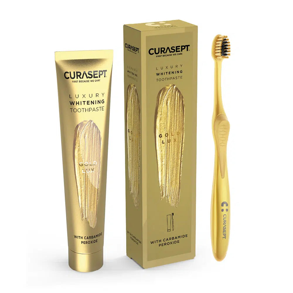 Curasept luxury whitening toothpaste tube and toothbrush set on a white background