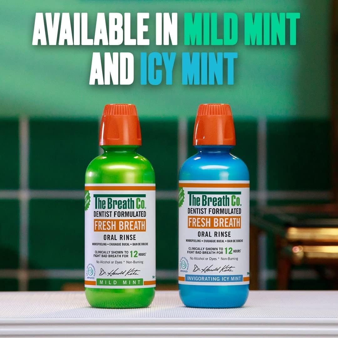 Two bottles of The Breath Co. Fresh Breath Oral Rinse with green and blue labels on a counter.