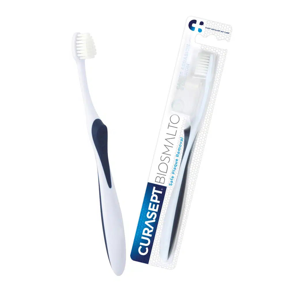 White toothbrush with blue accents and Curasept packaging on a white background