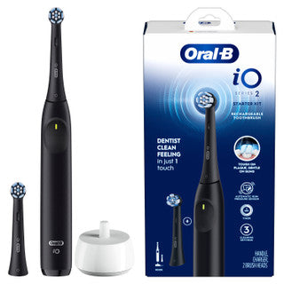 Black Oral-B electric toothbrush with packaging in the background